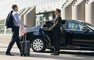 Professional Chauffeur Assisting Passenger with Limo Service