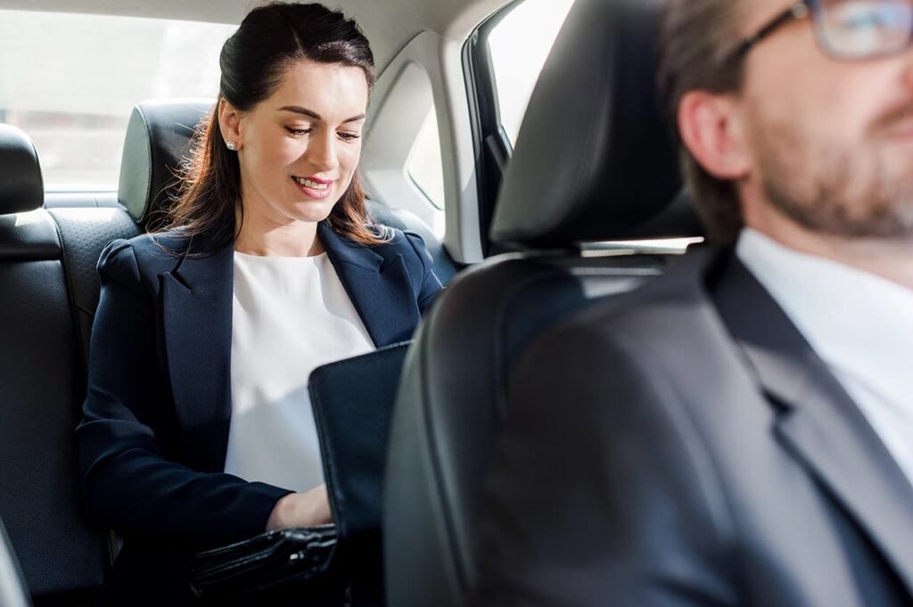 Businesswoman Enjoying a Chauffeur-Driven Limo Ride corporate limo service