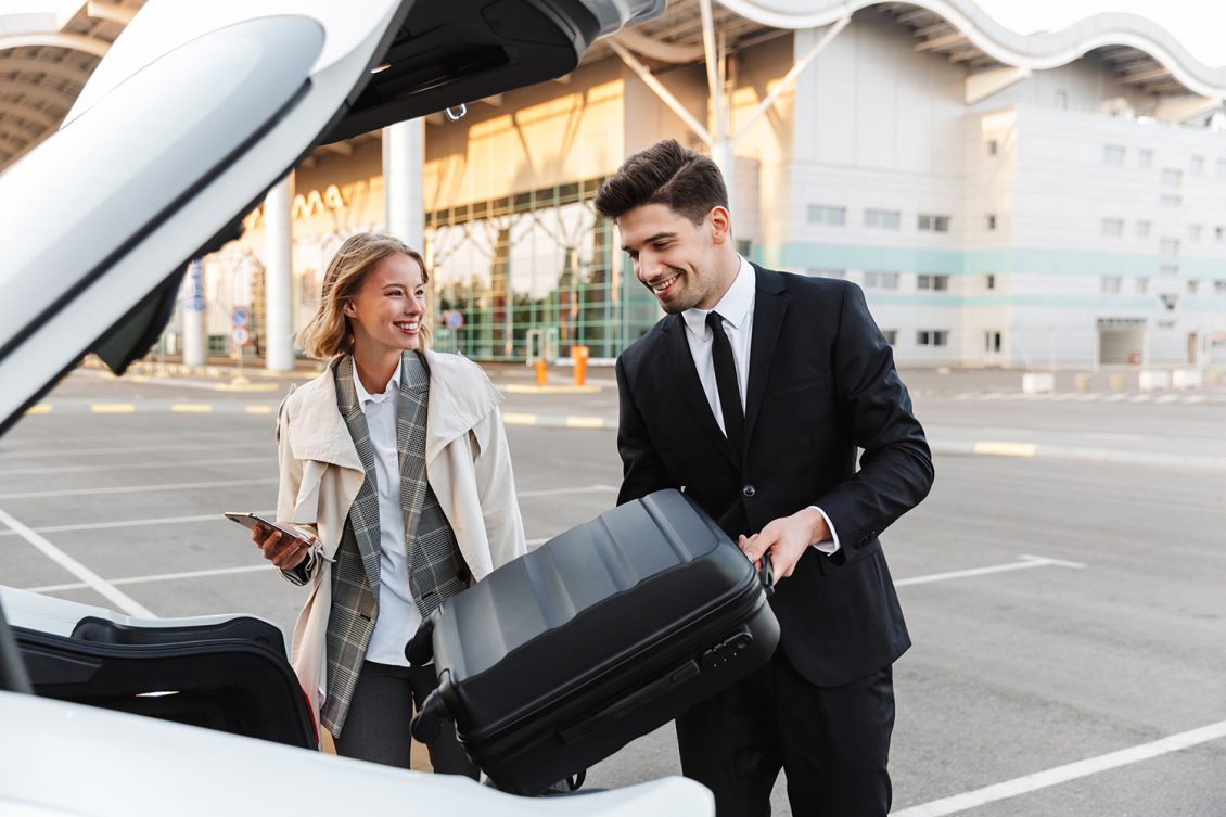 Chauffeur assisting a client with luggage for luxury transportation in Ocean County with Noor Limousine LLC limo service.