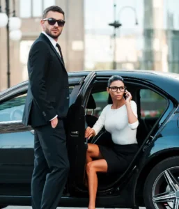 Luxury black car service in Bergen County with chauffeur assisting passenger from executive sedan
