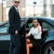 Luxury black car service in Bergen County with chauffeur assisting passenger from executive sedan