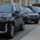 Black luxury SUVs lined up outside an airport terminal, showing premium Newark Airport limo service for business and travel.