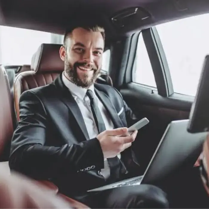 Professional chauffeur in a luxury black car providing premium limo service in Toms River, New Jersey